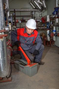 Engineer plumbers  testing central heating system using pressure test pump. Stock Photos