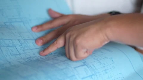 Engineer Points at Blueprint Plans on Office Table, Close-up Vídeos de archivo 336524946