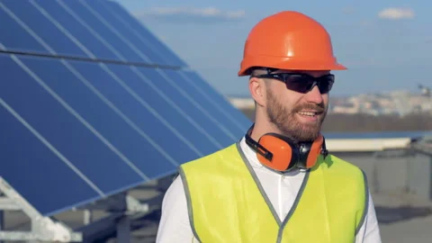 Engineer portrait. Smiling worker is turning his head and slightly lifting his Stock Footage 90779923