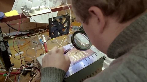 Engineer preparing new chip processor for installation on motherboard of Stock Footage 71054327