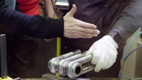 Engineer presenting holding new metal part Stock Footage 288865633