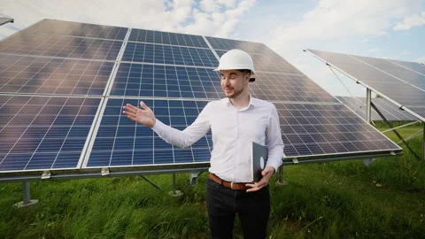 Engineer presenting solar panels in a renewable energy field Stock Footage 287570232