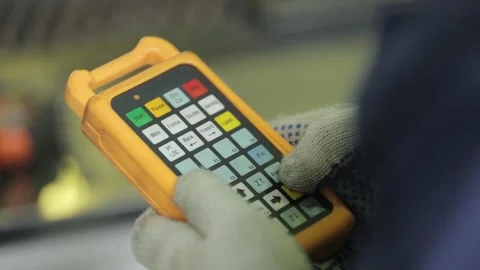 Engineer presses buttons on machine remote control close Stock Footage 138941418