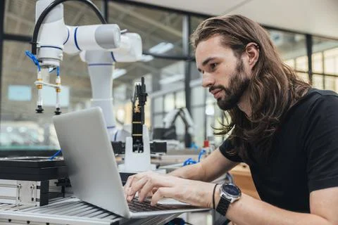 Engineer program robot code in Robotic lab test program robot prototype. Ro.. Stock Photos