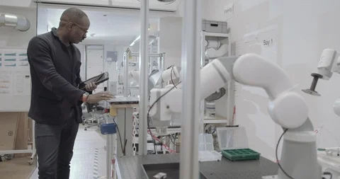 Engineer programming and testing robotics Stock Footage 121707178