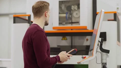 Engineer programming cnc machine in lab Stock Footage 142160188