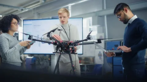 Engineer Programming Drone With Colleagues Stock Footage 189858613