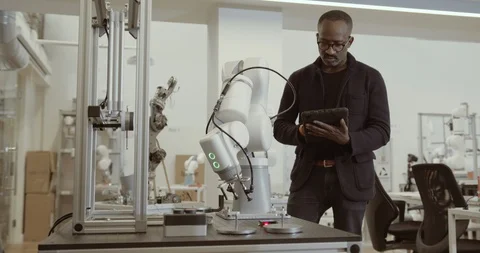 Engineer programming robotic arm Stock Footage 121677671