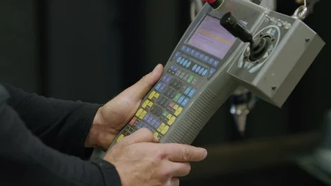 Engineer Programs Advanced Manufacturing Machine With Large Controller Interface Video stock 125176899