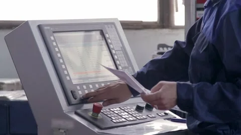 Engineer programs a machine on a plant Stock Footage 58907843