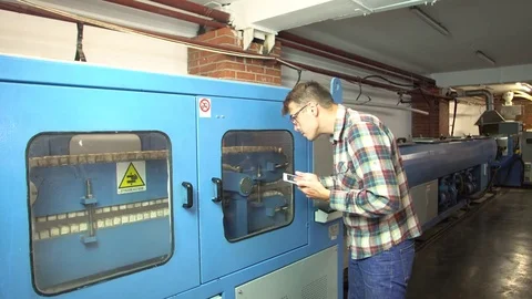 Engineer programs a machine for the production of propylene pipes 4k. Stock Footage 77826585