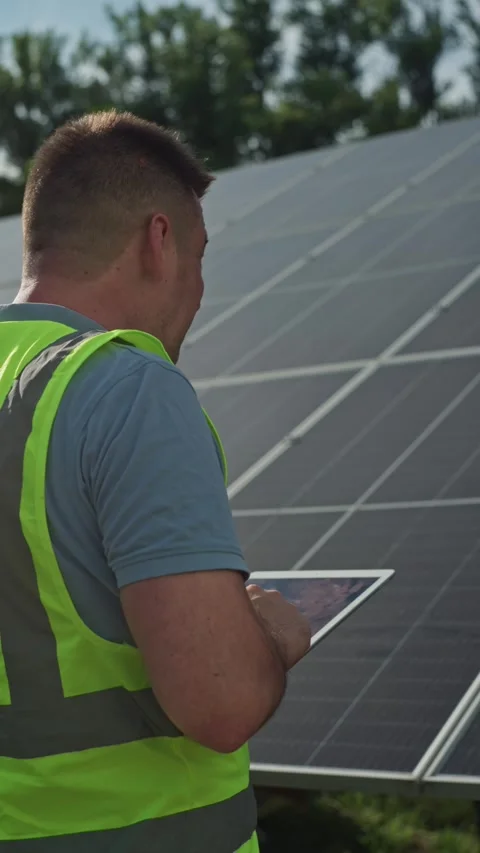 Engineer in Protective Clothing Managing Solar Panels Using Smartphone Stock Footage 289725383