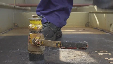 Engineer in protective clothing open valve and measures the level of oil Stock-Footage 116677660