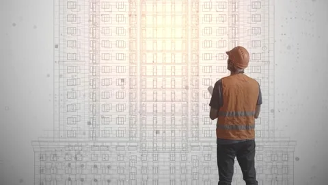 An engineer in a protective helmet and a vest with reflectors with a drawing in Stock Footage 233030403