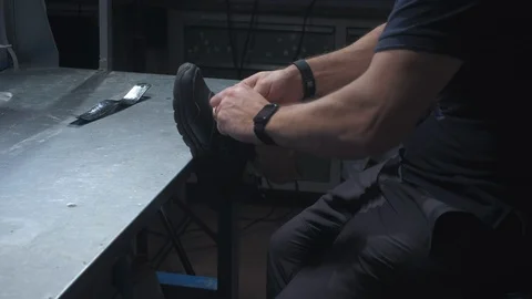 An engineer puts on sneakers on a prosthetic leg. Inserts the prosthesis into Stock Footage 120157394