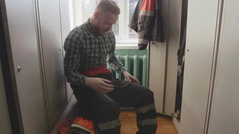 Engineer puts on uniform and helmet in locker room Stock Footage 109542683