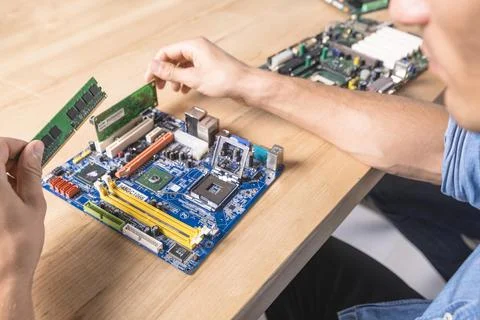 Engineer putting ram memory module motherboard Stock Photos