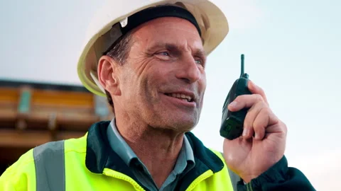 Engineer, radio and happy on construction site for progress, compliance update Stock Footage 336207610