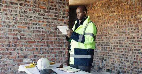 Engineer, reading and black man tablet for construction, inspection and res.. Stock Photos