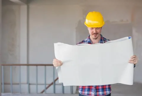 Engineer reading plan on blueprints Stock Photos