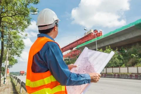Engineer reading plan or working on Construction site. Stock Photos