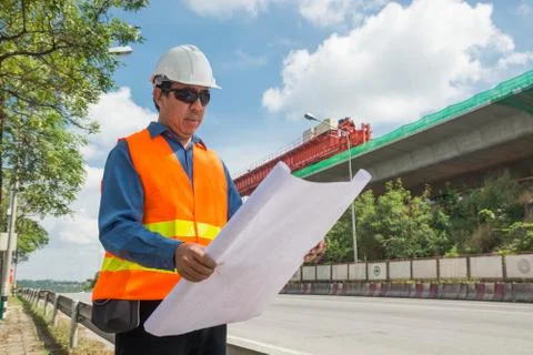 Engineer reading plan or working on Construction site. Stock Photos