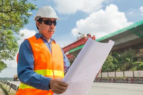 Engineer reading plan or working on Construction site. Stock Photos