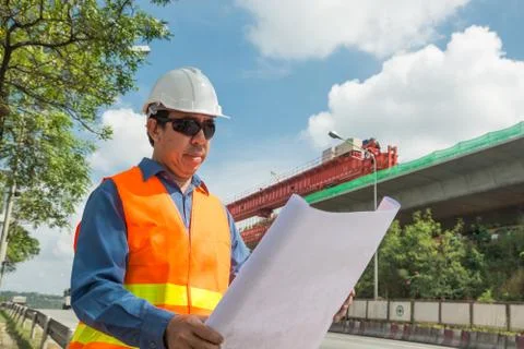 Engineer reading plan or working on Construction site. Stock Photos