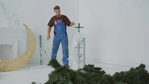 The engineer removes the cover-up from the metal trunk of artifisial Cristmass Stock-Footage 83199756