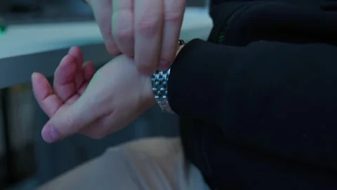 An engineer removes a mechanical watch on his hand, close-up shot Stock Footage 277516569