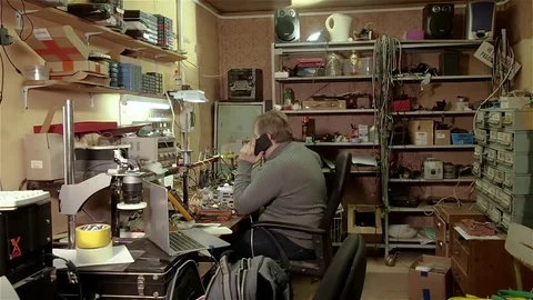 Engineer repair of computer equipment at work in his old workshop Video stock 71002298
