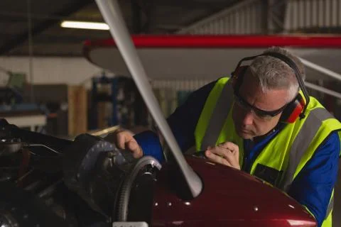 Engineer repairing aircraft engine 스톡 사진