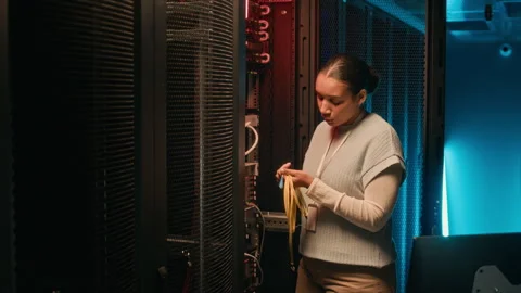 Engineer Repairing Cables in Server Room Stockbeeldmateriaal 311309729