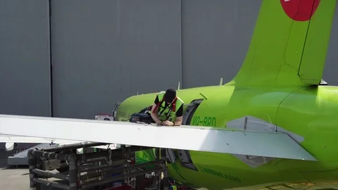 Engineer repairing wing of a passenger plane. Repair of the tail of the aircraft Stock Footage