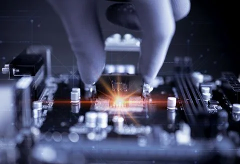 Engineer repairman computer plugging CPU microprocessor to motherboard. Stock Photos