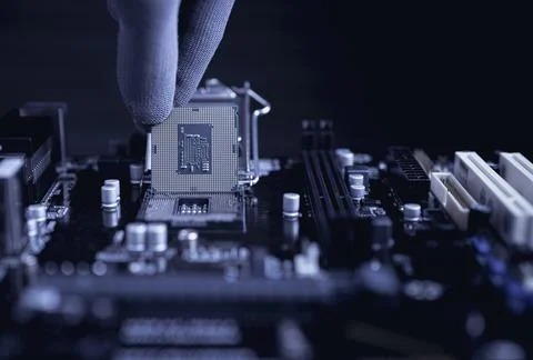 Engineer repairman computer uninstall CPU microprocessor to motherboard. Stock Photos