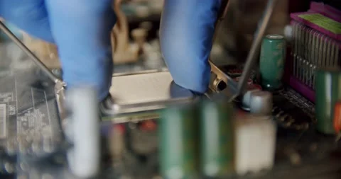 Engineer repairman holding chip processor CPU in hands to insert into the socket Stock Footage 151050042