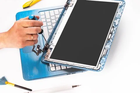 The engineer repairs blue laptop, pc, computer and the screen. laptop scree.. Stock Photos