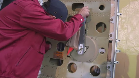 Engineer repairs the door of a passenger plane. The plane in the door repair. 4k Видео 98000625