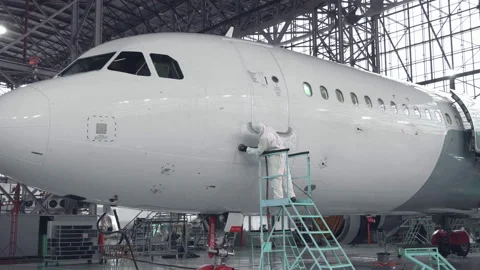 Engineer repairs the door of a passenger plane. The plane in the door repair. 4k Stock Footage 107284188