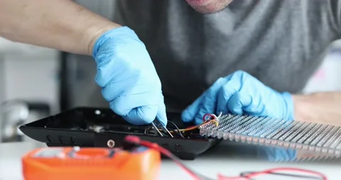 Engineer repairs electric lighting equipment and technical computer equipment Stock Footage 194413785