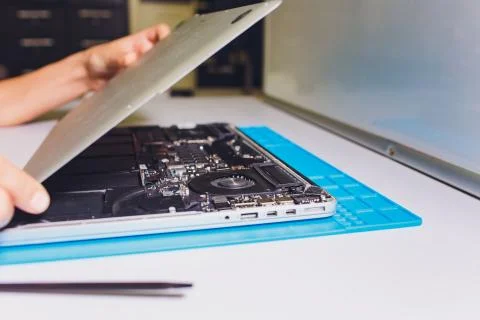 The engineer repairs the laptop pc, computer and the motherboard. Installs the Stock Photos