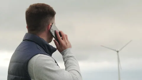Engineer reports about functioning wind turbine on phone Video stock 204871053