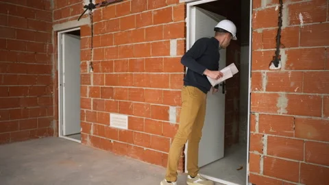 Engineer reviewing construction documentation during commercial development.. Stock Footage 329641217