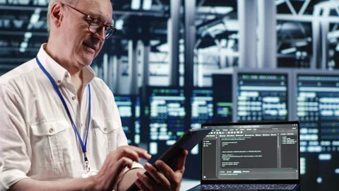 Engineer running code in data center Stock Footage 247900544