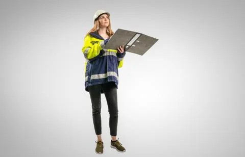 Engineer in safety equipment with a file folder against a white background Stock Photos