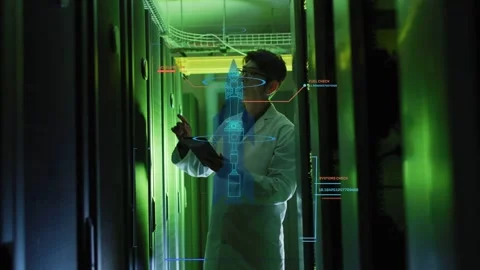 Engineer scanning racks with tablet in data center, summoning AR schematic and Stock Footage 332591935