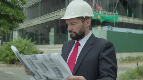 An engineer, scientist and developer at a construction site checks on the Video stock 168102357