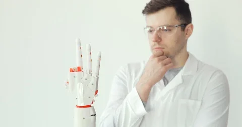 Engineer scientist is testing robotic prosthesis hand which makes movements with Stock Footage 106220967