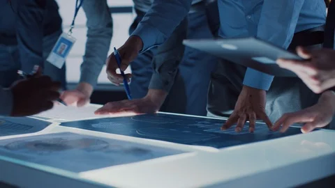Engineer, Scientists and Developers Gathered Around Illuminated Conference Table Stock-Footage 104801005